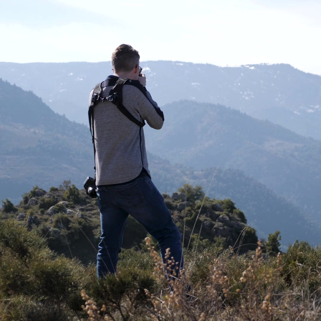 Josh adjusting his camera settings in the field